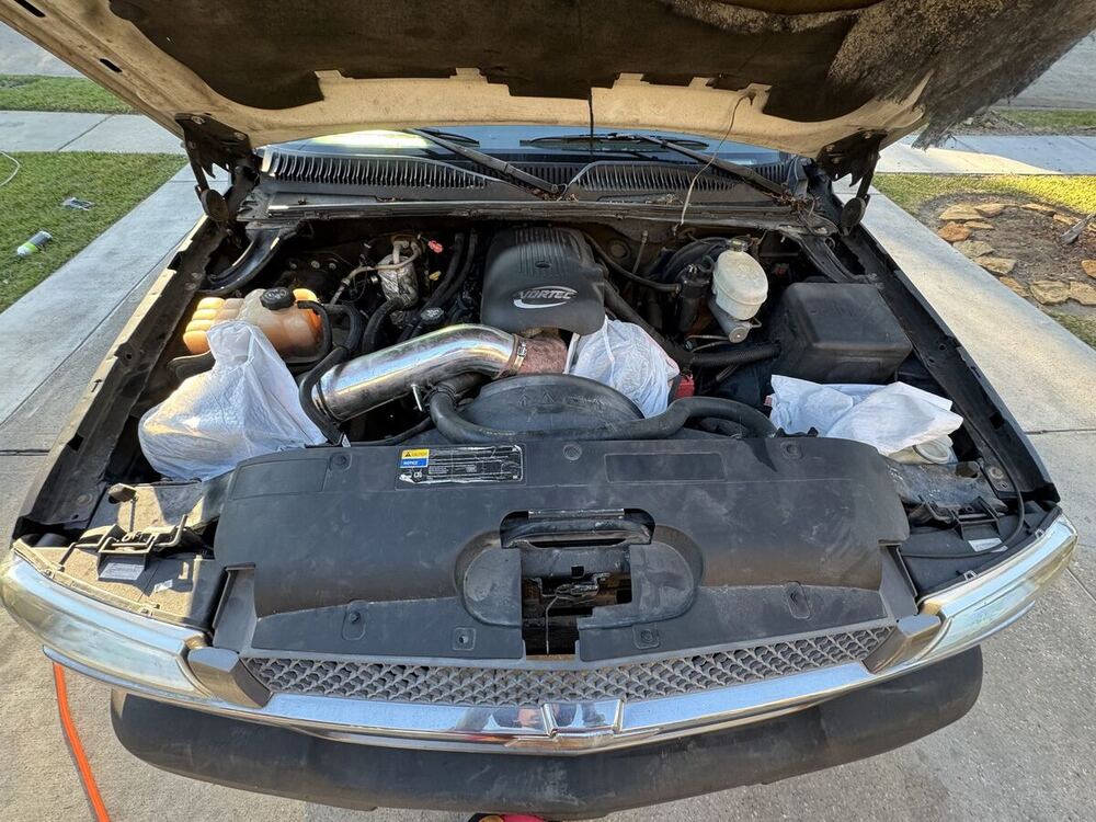 Engine bay before detailing — dusty and dirty